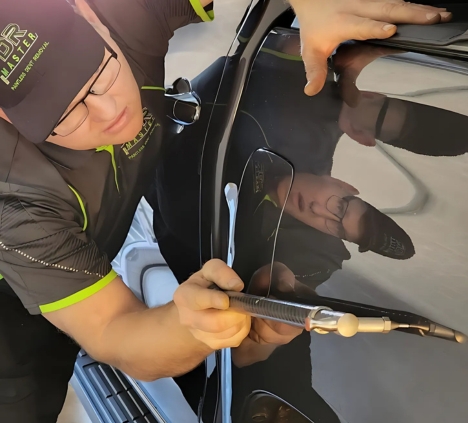 PDR Master technician performing paintless dent removal
